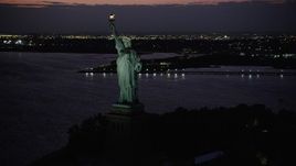 4K aerial stock footage Flying by Statue of Liberty, Liberty Island, New York, New York, twilight Aerial Stock Footage | AX89_139