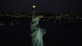 4K aerial stock footage Flying by the Statue of Liberty, Liberty Island, New York, New York, night Aerial Stock Footage | AX89_142