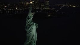 4K aerial stock footage Flying by Statue of Liberty, revealing Lower Manhattan, New York, night Aerial Stock Footage | AX89_143