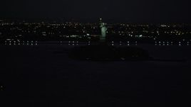 4K aerial stock footage Approaching Statue of Liberty, Liberty Island, New York, New York, night Aerial Stock Footage | AX89_144