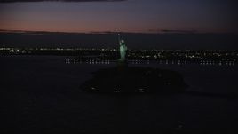 4K aerial stock footage Flying by Statue of Liberty, Liberty Island, New York, New York, night Aerial Stock Footage | AX89_145