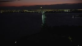 4K aerial stock footage Flying by Statue of Liberty, Liberty Island, New York, New York, night Aerial Stock Footage | AX89_146