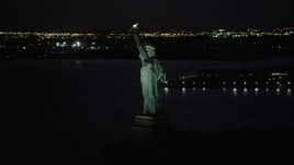 4K aerial stock footage Flying by Statue of Liberty, Liberty Island, New York, New York, night Aerial Stock Footage | AX89_147