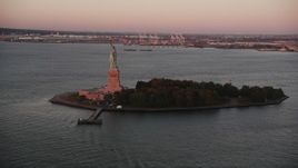 4K aerial stock footage Flying by Statue of Liberty, Liberty Island, New York, New York, sunrise Aerial Stock Footage | AX90_013