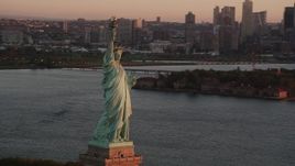 4K aerial stock footage Flying by Statue of Liberty, Liberty Island, New York, New York, sunrise Aerial Stock Footage | AX90_021