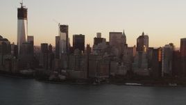 4K aerial stock footage Flying over New York Harbor, revealing Lower Manhattan, New York, sunrise Aerial Stock Footage | AX90_022
