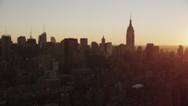 4K aerial stock footage Flying by Empire State Building, Midtown Manhattan, New York, sunrise Aerial Stock Footage | AX90_029