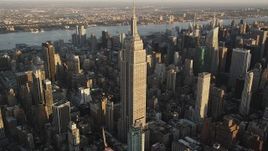 4K aerial stock footage Flying by the Empire State Building, Midtown Manhattan, New York, sunrise Aerial Stock Footage | AX90_053