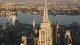 4K aerial stock footage Flying by Empire State Building, Midtown Manhattan, New York, sunrise Aerial Stock Footage | AX90_055