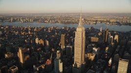 4K aerial stock footage Flying by Empire State Building, Midtown Manhattan, New York, sunrise Aerial Stock Footage | AX90_056