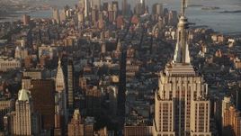 4K aerial stock footage Flying by Empire State Building, Midtown Manhattan, New York, sunrise Aerial Stock Footage | AX90_059