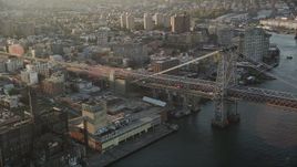 4K aerial stock footage Flying by Williamsburg Bridge, East River, New York, New York, sunrise Aerial Stock Footage | AX90_096