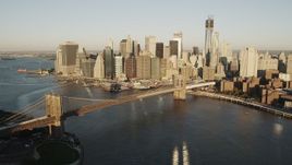 4K aerial stock footage Flying by Brooklyn Bridge, Lower Manhattan skyline, New York, New York, sunrise Aerial Stock Footage | AX90_101