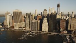 4K aerial stock footage Flying by Lower Manhattan skyscrapers, East River, New York, New York, sunrise Aerial Stock Footage | AX90_103