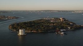 4K aerial stock footage Approaching Governors Island, New York, New York, sunrise Aerial Stock Footage | AX90_106