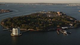 4K aerial stock footage Approaching Governors Island, New York Harbor, New York, New York, sunrise Aerial Stock Footage | AX90_107
