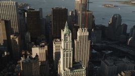 4K aerial stock footage Flying away from Woolworth Building, Lower Manhattan, New York, sunrise Aerial Stock Footage | AX90_120