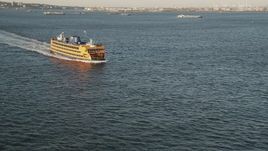 4K aerial stock footage Flying by Staten Island Ferry on New York Harbor, New York, New York, sunrise Aerial Stock Footage | AX90_128