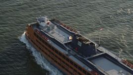 4K aerial stock footage Tracking the Staten Island Ferry cruising New York Harbor, New York, sunrise Aerial Stock Footage | AX90_136