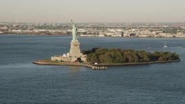 4K aerial stock footage Approaching the Statue of Liberty, New York Harbor, New York, New York, sunrise Aerial Stock Footage | AX90_137