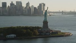 4K aerial stock footage Approaching Statue of Liberty, Lower Manhattan, New York, sunrise Aerial Stock Footage | AX90_146