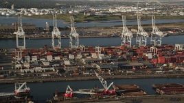 4K aerial stock footage Approaching cargo cranes, containers, Port Jersey, New Jersey, sunrise Aerial Stock Footage | AX90_156