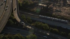 4K aerial stock footage Tracking a commuter train, Jersey City, New Jersey, sunrise Aerial Stock Footage | AX90_161