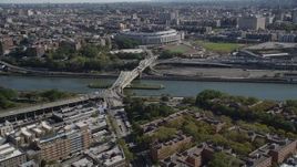 4K aerial stock footage tilt from Harlem apartment buildings, reveal Macombs Dam Bridge and Yankee Stadium in The Bronx, New York Aerial Stock Footage | AX91_017