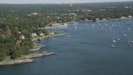 4K aerial stock footage of flying by sailboats and oceanfront mansions by yacht club, Larchmont, New York Aerial Stock Footage | AX91_035