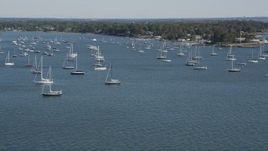 4K aerial stock footage of tilting from the ocean to reveal sailboats near the coast, Rye, New York Aerial Stock Footage | AX91_040