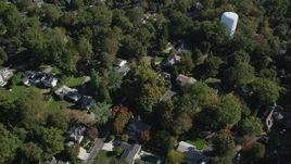 4K aerial stock footage of tilting to suburban homes and neighborhoods with trees in Norwalk, Connecticut Aerial Stock Footage | AX91_094