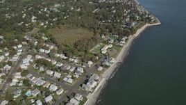 4K aerial stock footage of flying by homes near the beach in Milford, Connecticut Aerial Stock Footage | AX91_129