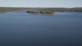 4K aerial stock footage of flying over Lake Gallard, revealing small island in autumn, Lake Gallard, Connecticut Aerial Stock Footage | AX91_157