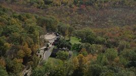 4K aerial stock footage of flying over forest, revealing homes in autumn, Guilford, Connecticut Aerial Stock Footage | AX91_171