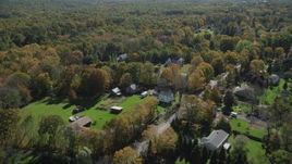 4K aerial stock footage of flying over forest and suburban homes, autumn, Guilford, Connecticut Aerial Stock Footage | AX91_173