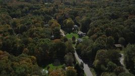 4K aerial stock footage of flying over forest, road and homes in autumn, Guilford, Connecticut Aerial Stock Footage | AX91_178
