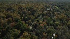 4K aerial stock footage of flying over forest road and rural homes in autumn, Guilford, Connecticut Aerial Stock Footage | AX91_179