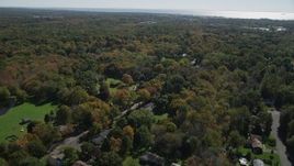 4K aerial stock footage of approaching suburban homes and forests in autumn, Guilford, Connecticut Aerial Stock Footage | AX91_181