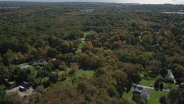 4K aerial stock footage of flying over suburban neighborhoods and forests in autumn, Guilford, Connecticut Aerial Stock Footage | AX91_182
