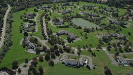 4K aerial stock footage of flying over upscale homes near a small pond in Southampton, New York Aerial Stock Footage | AX91_209