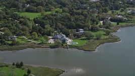 4K aerial stock footage of flying by a waterfront mansion in Southampton, New York Aerial Stock Footage | AX91_211