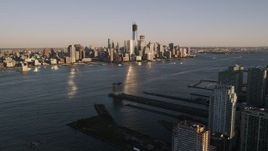 4K aerial stock footage of Lower Manhattan, across the Hudson River, New York, New York, sunset Aerial Stock Footage | AX93_002