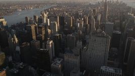 4K aerial stock footage Flying by Midtown Manhattan skyscrapers, tilt down, New York, New York, sunset Aerial Stock Footage | AX93_029