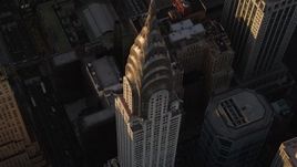 4K aerial stock footage Flying away from Chrysler Building, tilting up, Midtown Manhattan, New York, sunset Aerial Stock Footage | AX93_050