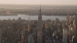 4K aerial stock footage flying by the Empire State Building, Midtown Manhattan, New York, sunset Aerial Stock Footage | AX93_052