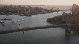 4K aerial stock footage Panning from Williamsburg Bridge to Lower Manhattan, New York, sunset Aerial Stock Footage | AX93_060