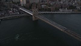 4K aerial stock footage Panning across Brooklyn Bridge to Lower Manhattan side, New York, New York, sunset Aerial Stock Footage | AX93_081