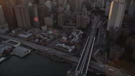 4K aerial stock footage of Lower Manhattan side of Brooklyn Bridge, reveal skyscrapers, New York, sunset Aerial Stock Footage | AX93_082