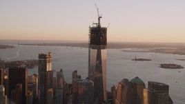 4K aerial stock footage Flying by the top of One World Trade Center, Lower Manhattan, New York, sunset Aerial Stock Footage | AX93_089