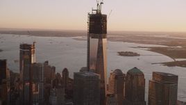 4K aerial stock footage Flying by the top of One World Trade Center, Lower Manhattan, New York, sunset Aerial Stock Footage | AX93_090